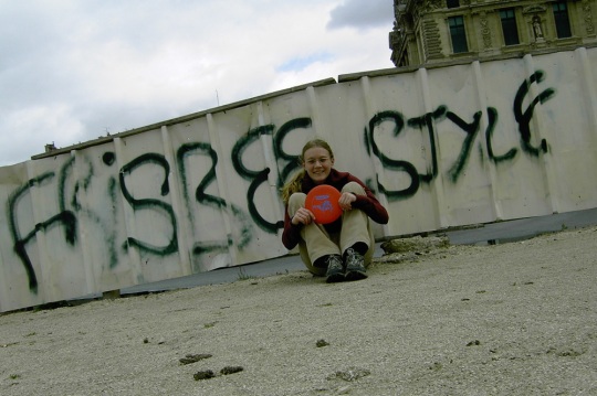 Jenny Cook in front of some Frisbee-themed graffiti in France. 
